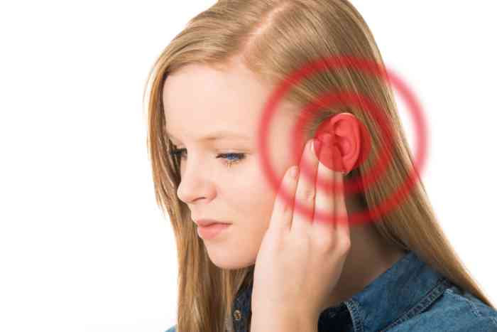A girl with earache touching her ear