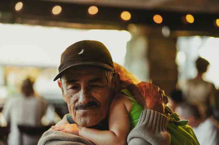 A grandfather hugging his grandchild