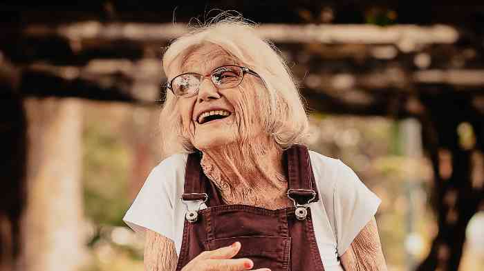An old woman with glasses smiling