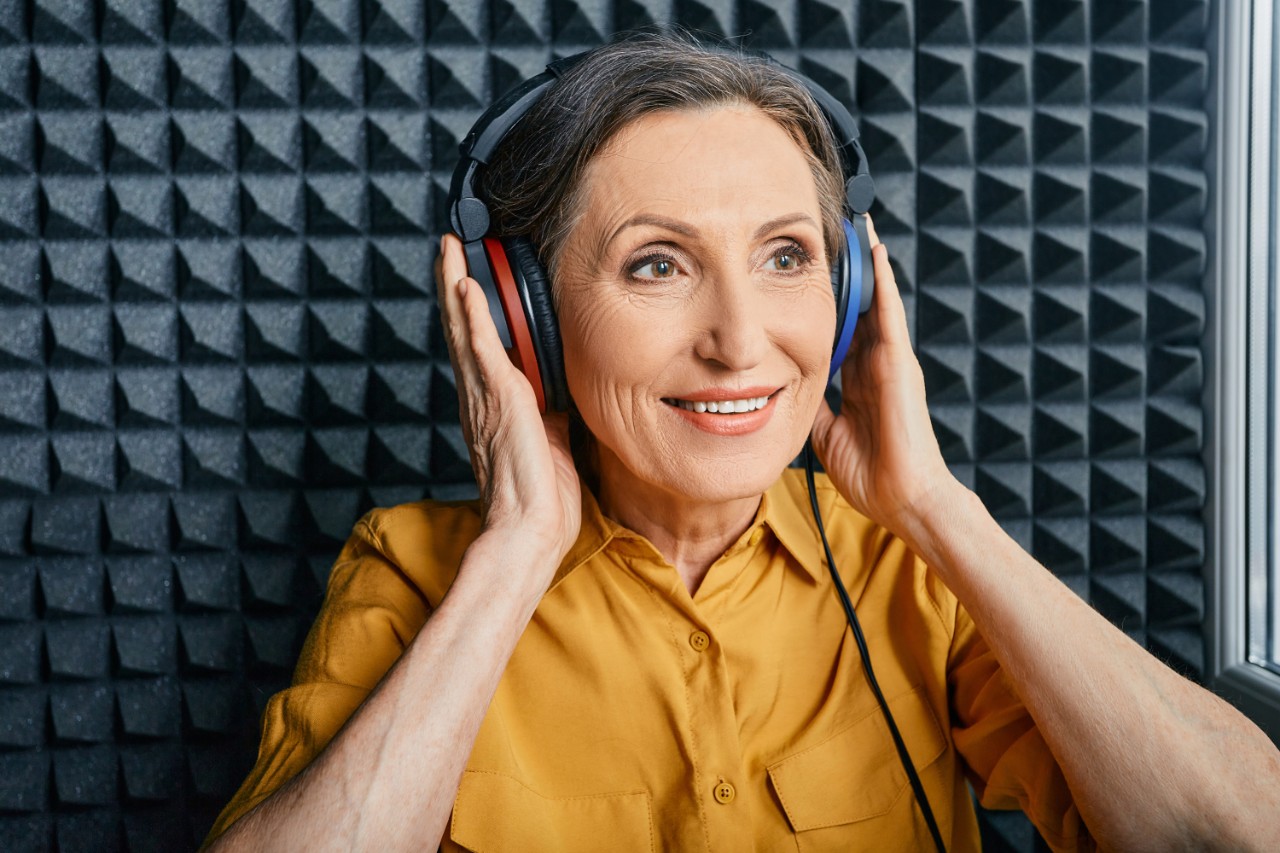 A woman with a yellow shirt perfoming a hearing test