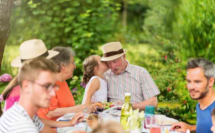 Grandfather and grandchild enjoyning lunch with the family 