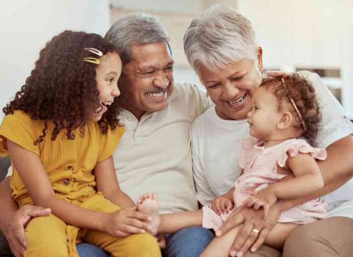 Grandparents smiling with their granddaughters