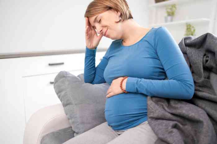 Pregnant woman expressing headache and earache