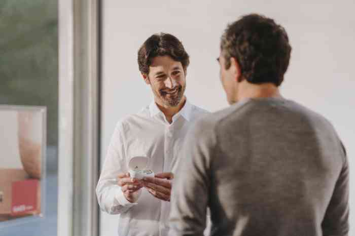 Two men smiling to each other