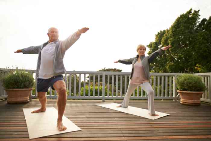 two people doing yoga on a porch