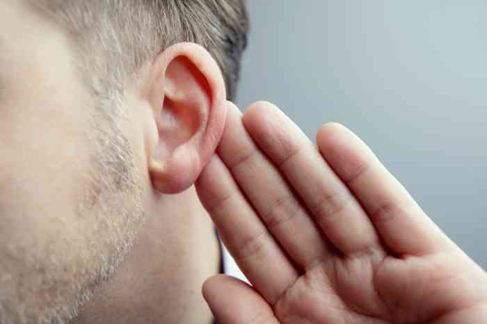 A man holding his ear 