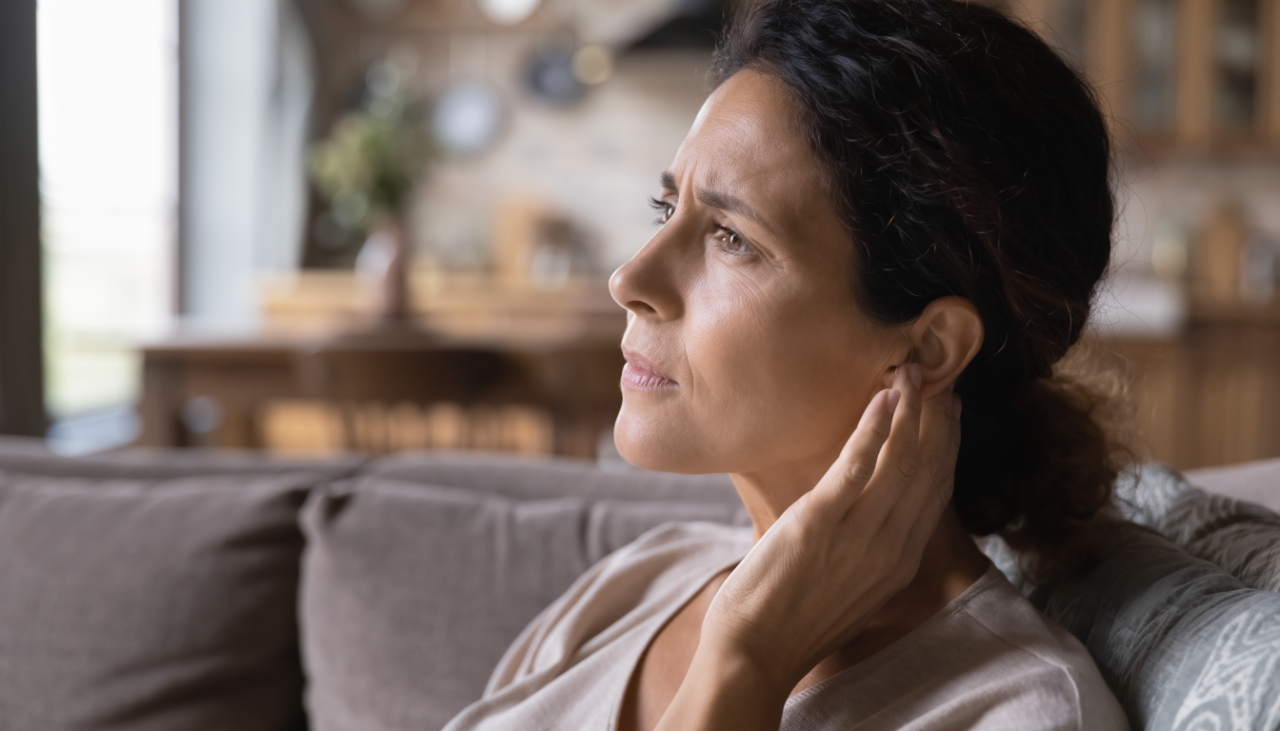 A woman holding his ear