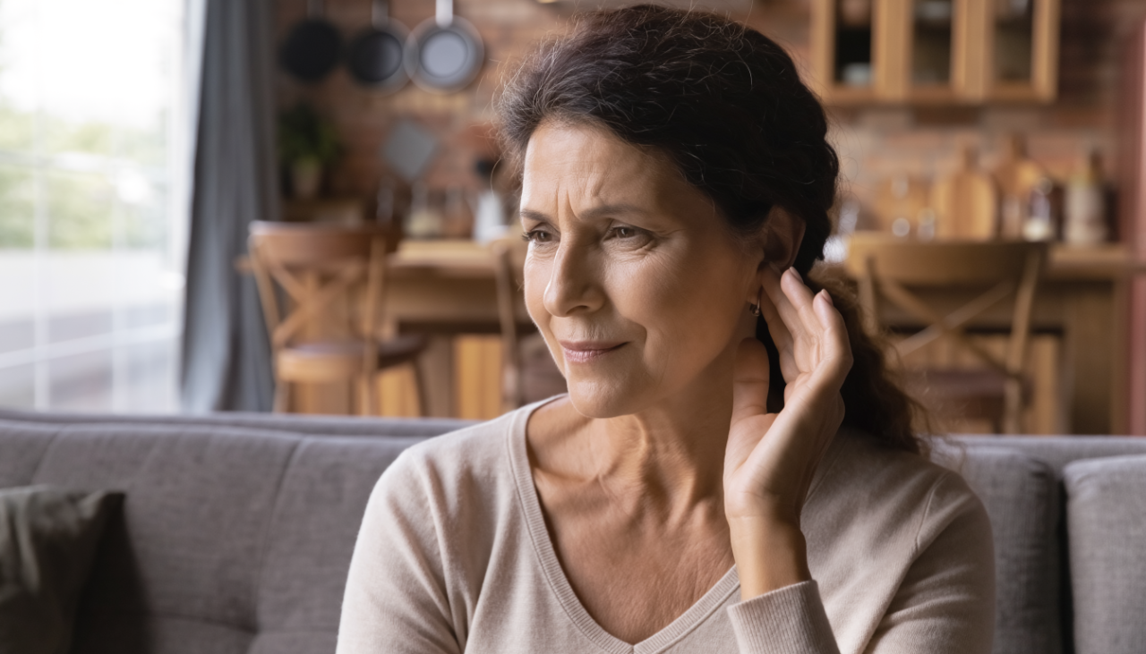 A woman touching her ear