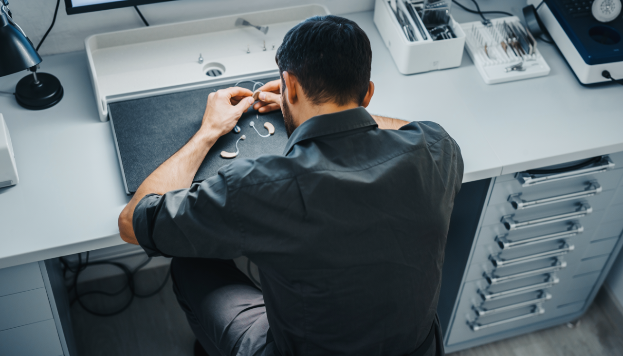 A man repairing a hearing aid