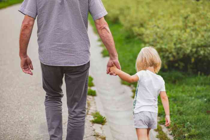 Grandfather walking with his granddaughter