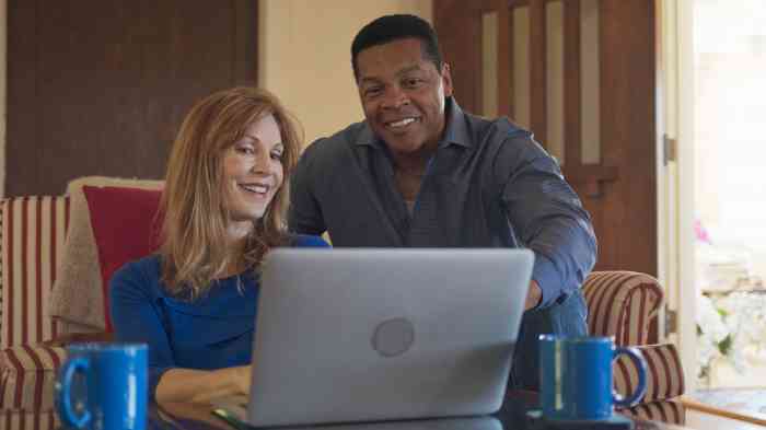 a couple looking at a laptop