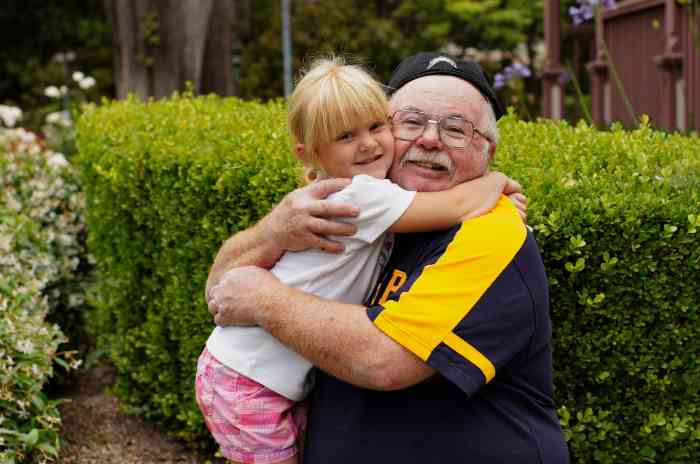 A grandfather hugging his grandchild