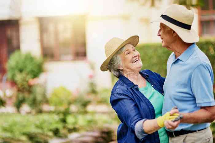 Old couple gardening and smiling