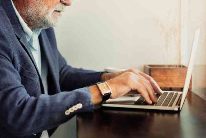 Elderly man is using computer laptop