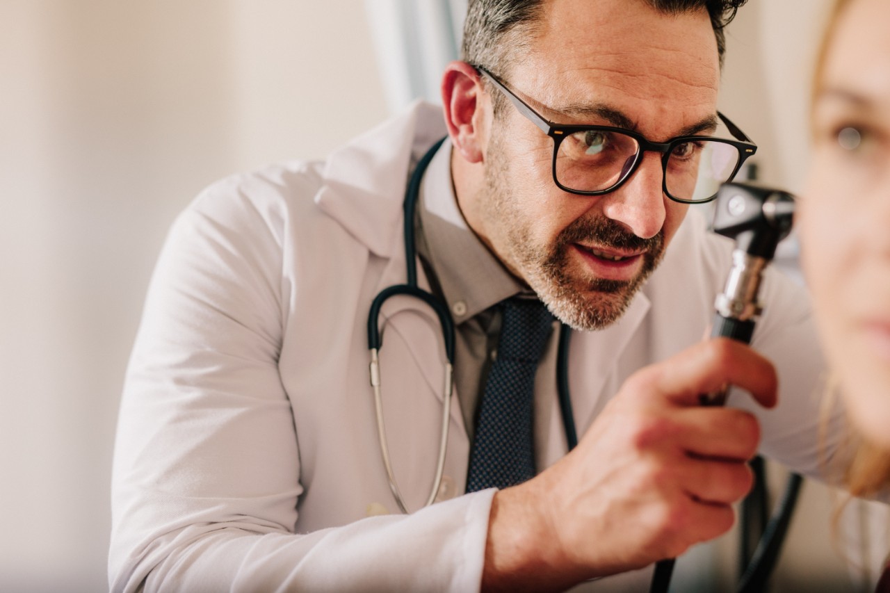 A doctor conducting an ear exam