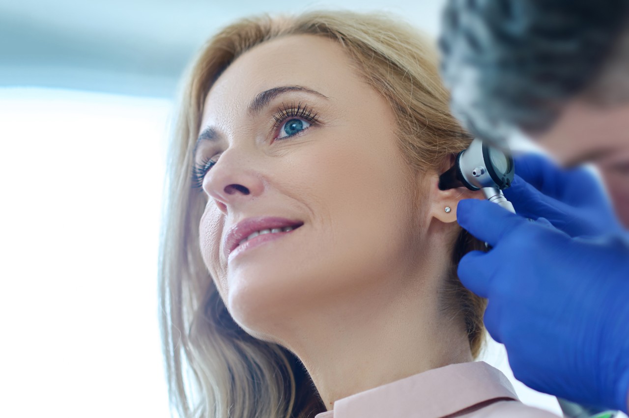 Doctor measuring patient hearing level