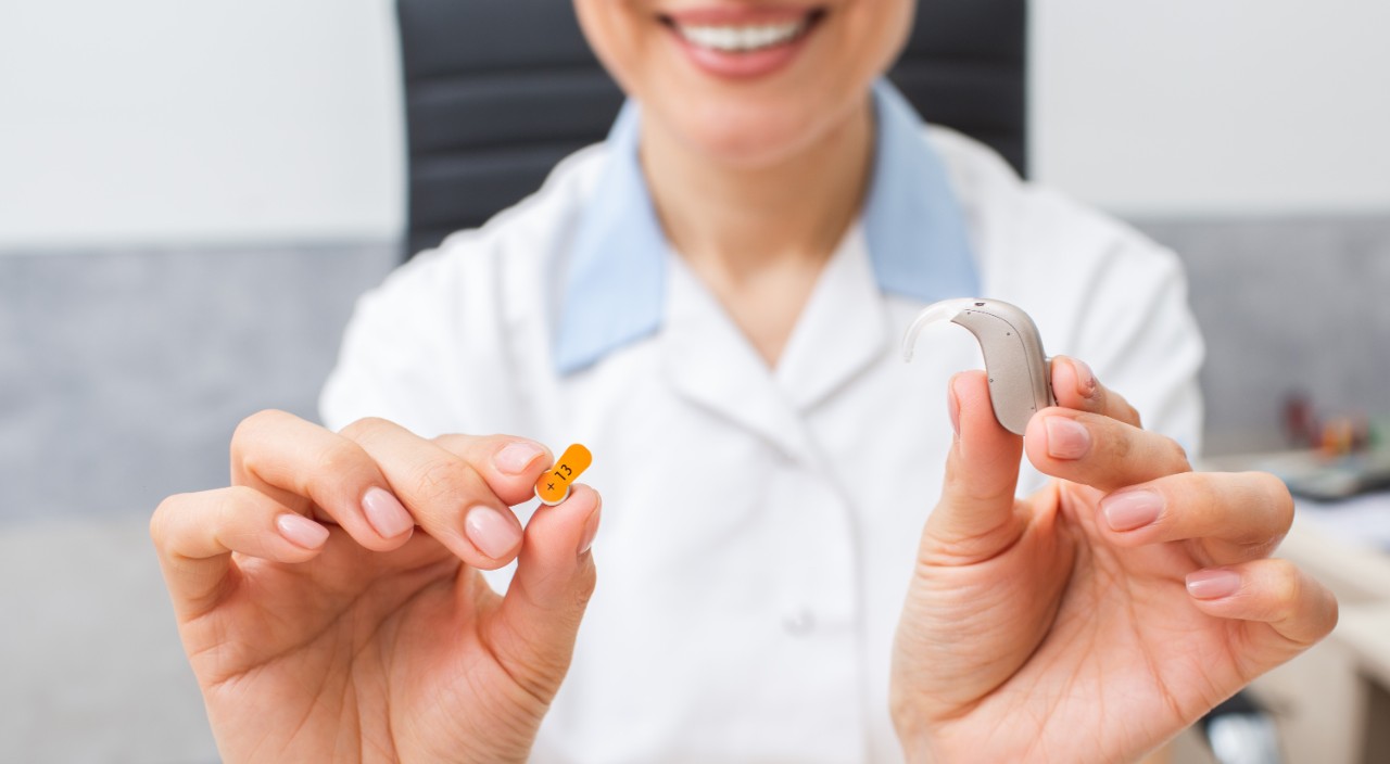 Audiologist showing a hearing aid