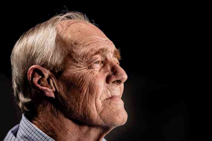 Profile of an old man wearing hearing aid